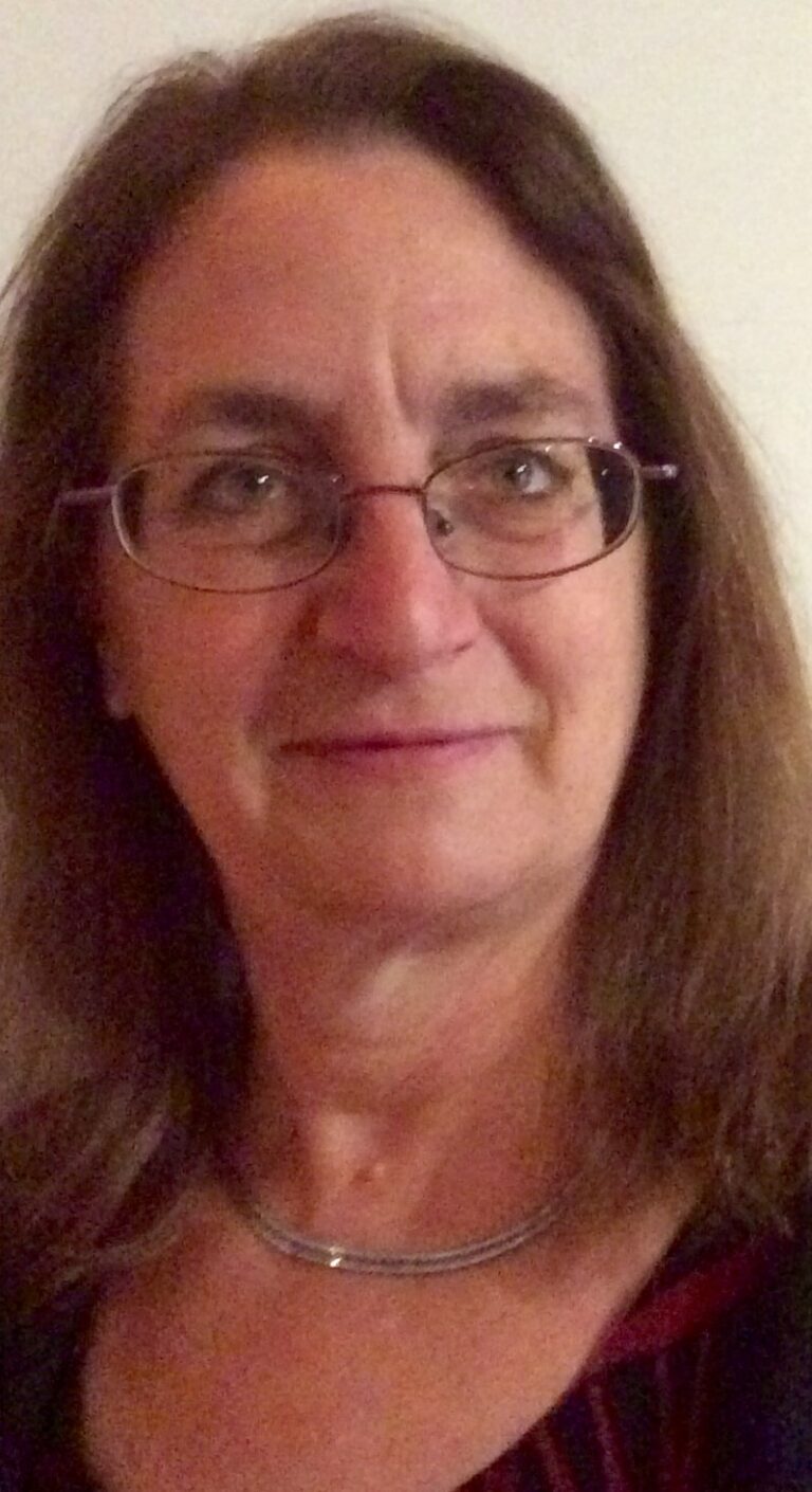 Image of American Music Therapist, Elizabeth K. Schwartz. She has shoulder-length brown hair and glasses and is wearing a black shirt.